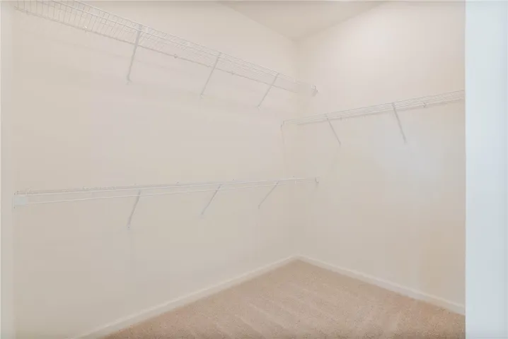 Customizable storage solutions define this practical walk-in closet.