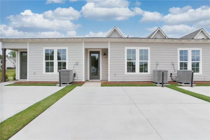 Clean lines and light siding define this modern multi-unit exterior, offering designated entryways.