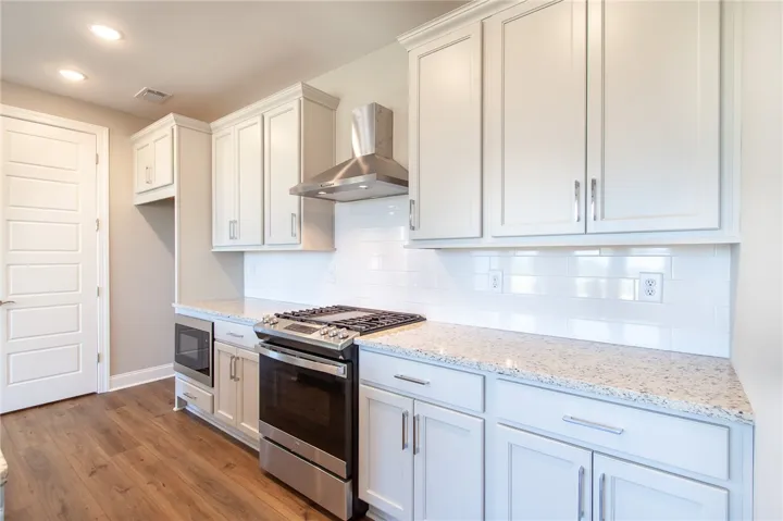 Bright and inviting, this kitchen offers ample counter space and modern appliances for culinary ease.