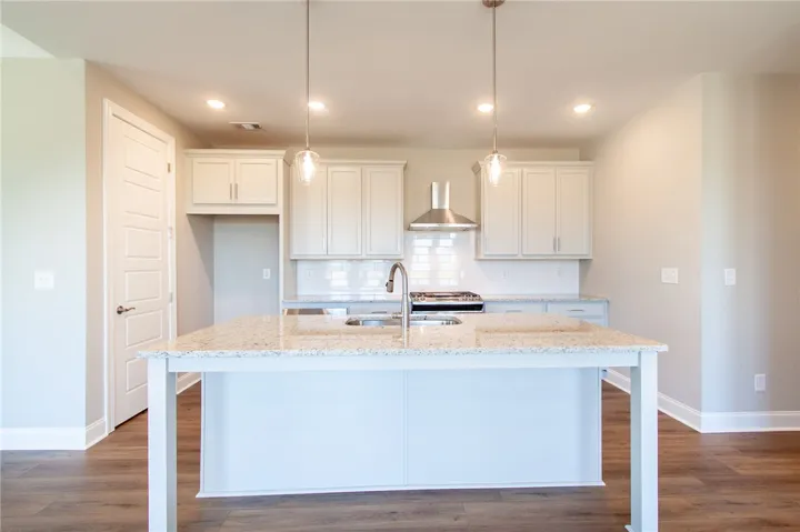 This bright kitchen features a spacious island and modern amenities.