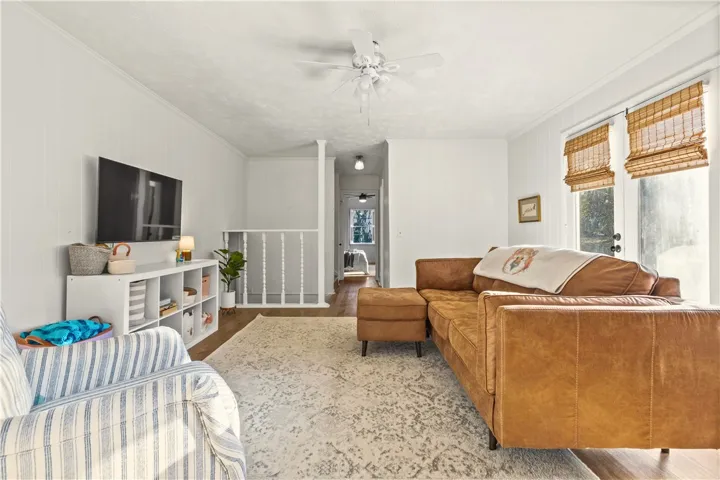 View leading towards owner's suite, half stairs back to foyer & tucked stairway to go to guest bedrooms on second floor.
