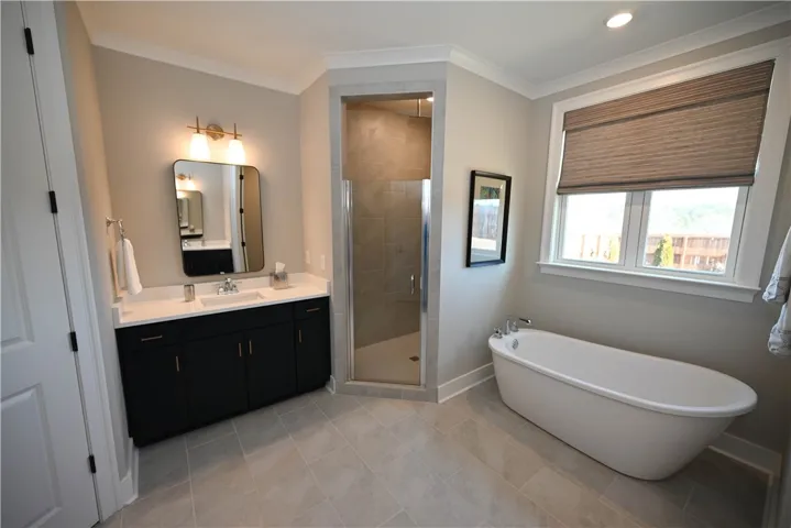 2 walk-in closets with custom shelving, free standing soaking tub, and dual vanities.