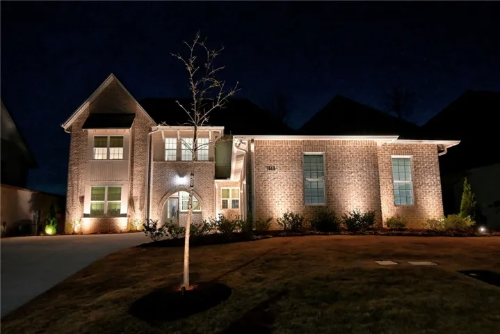 Perfected with custom outdoor lighting and landscape.