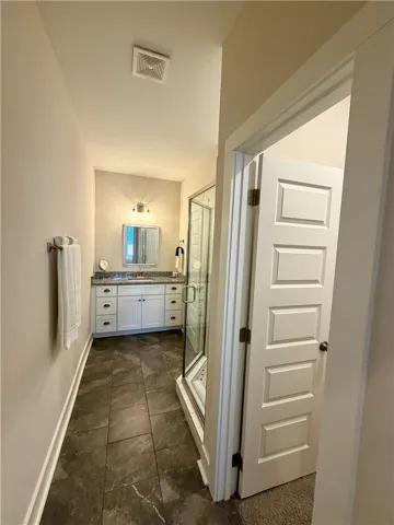 Primary suite bathroom with walk in closet