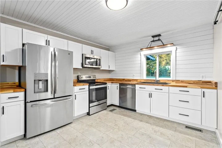 New butcher block countertops, new lighting new deep kitchen sink