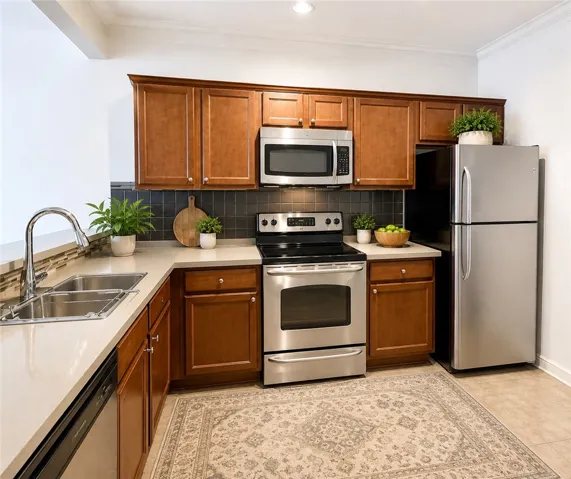 A well-appointed kitchen features rich wood cabinetry and gleaming stainless steel appliances.