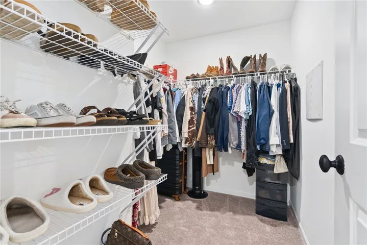 abundance of storage space in large walk-in closet to primary bedroom