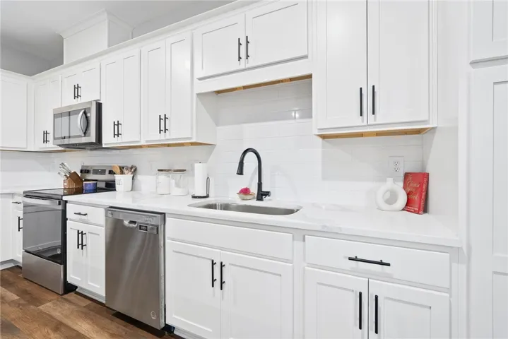 Sleek quartz countertops and stainless steel appliances