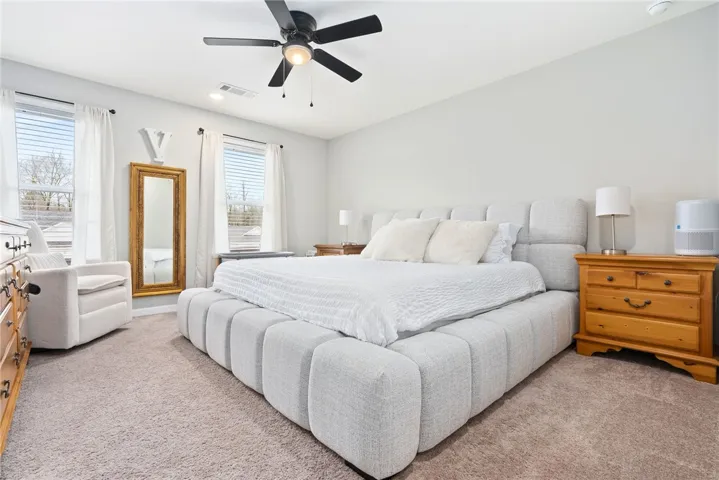 Primary bedroom with great natural light and spacious enough for extra seating or desk area