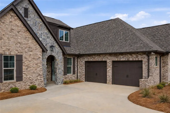 The courtyard-entry garage maintains the home’s clean front elevation while providing a spacious driveway.