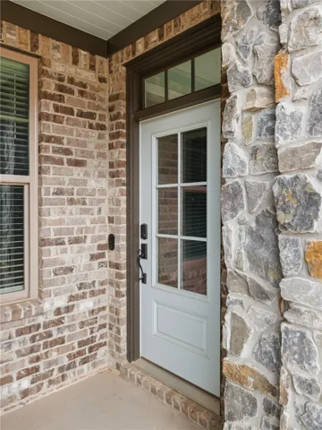 The front door is tucked beneath a covered porch.