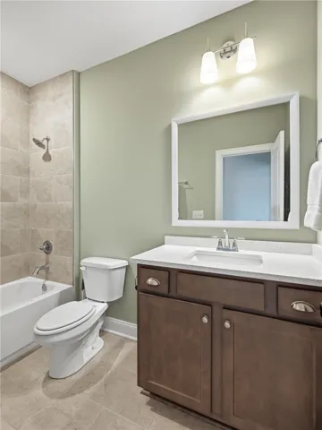 The shared bath for bedrooms two and three features a tiled tub surround that adds a polished touch.