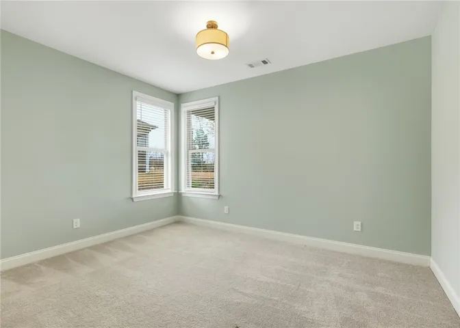Bedroom 3 overlooks the rear yard.