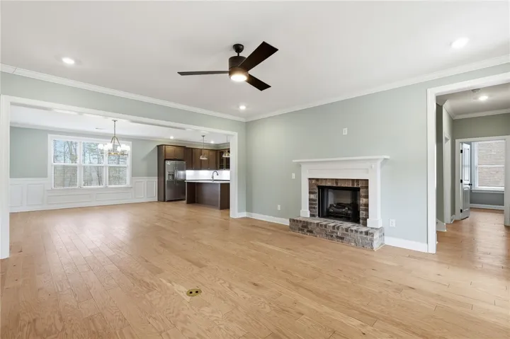 The foyer opens to a vast living room anchored by a gas fireplace.