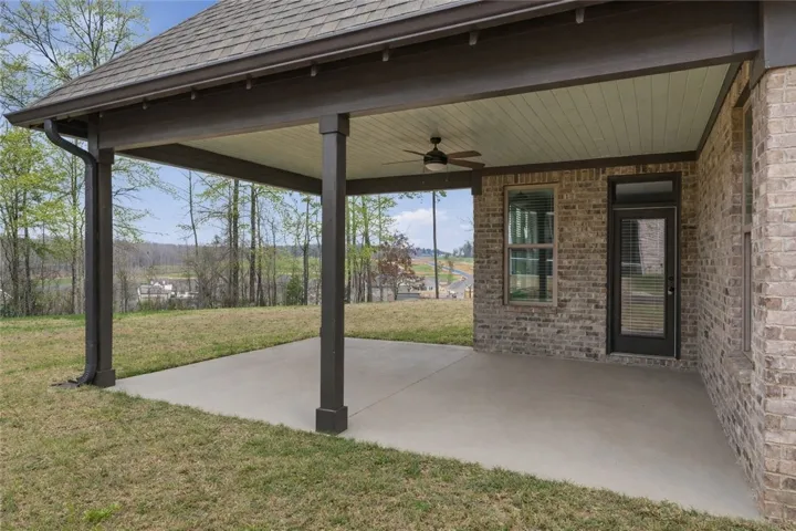 Just off the kitchen’s dining area and open to the living room, the covered porch extends the home’s living space outdoors.