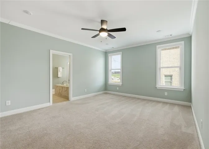 The primary bedroom offers a serene atmosphere and flexible layout, with multiple options for bed placement—including between two windows.