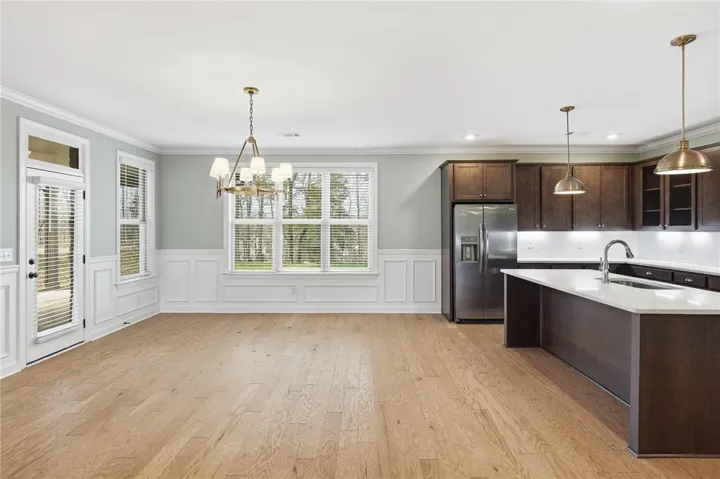 An open dining area maintains seamless flow between rooms, while the island provides additional seating.