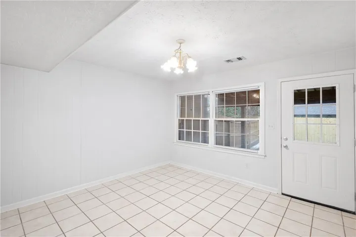 Den or Dining Room  This room is large enough to use as a den.  Located on the other side of the kitchen with access to the backyard.