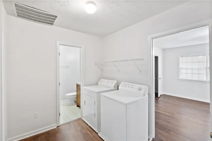 Upstairs Landing holds a laundry area conveniently located between 3 bedrooms.