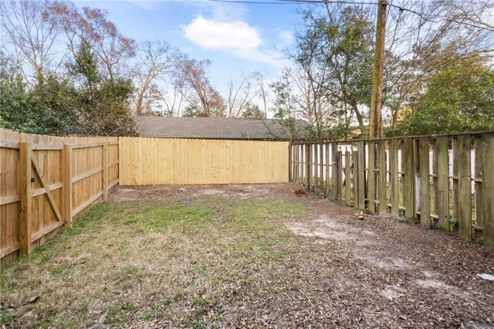 Backyard with new privacy fence on back boundary line.