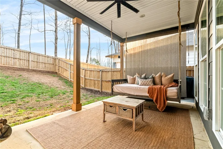 Covered back porch complete with bed swing