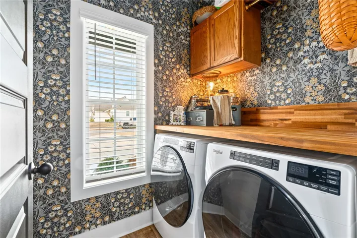 Laundry room with added wall paper and storage