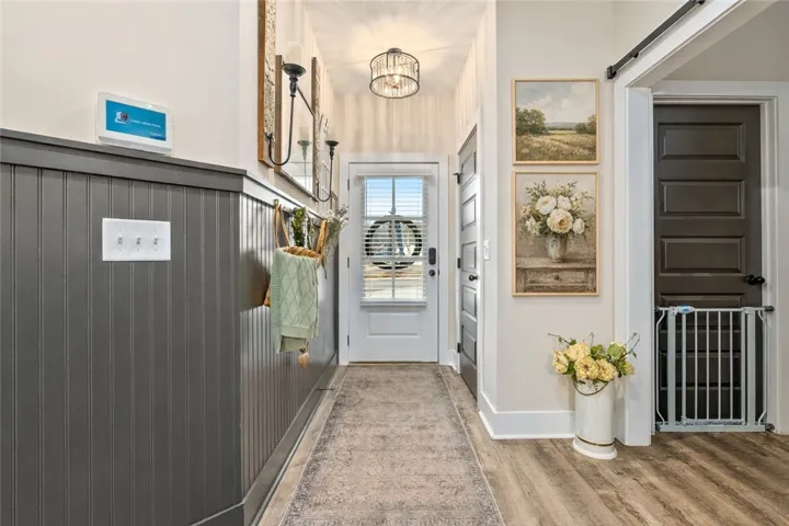 Entryway with accent wall and designer lighting