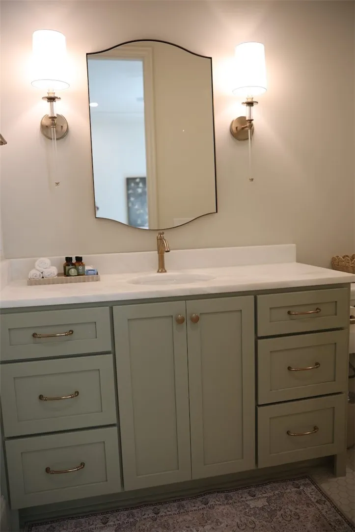 A well-appointed bathroom vanity with a crisp white countertop and stylish fixtures.