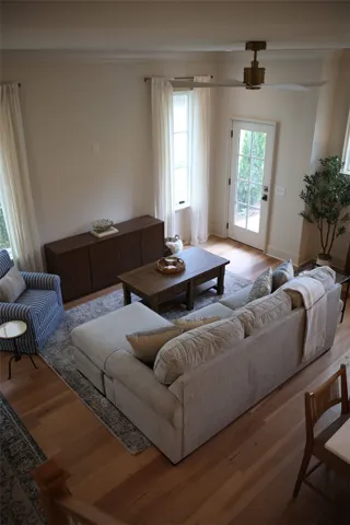 Hardwood floors and a ceiling fan enhance this inviting living space, providing comfort and style.