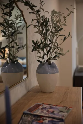 Reflecting elegance, a sleek mirror enhances the interior, offering both style and depth.