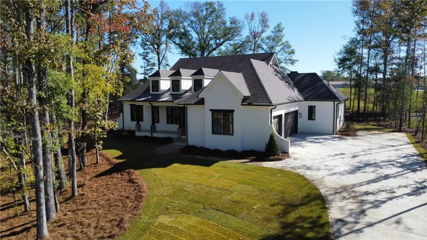 Gable rooflines and dark-framed windows define the striking exterior of this modern design.