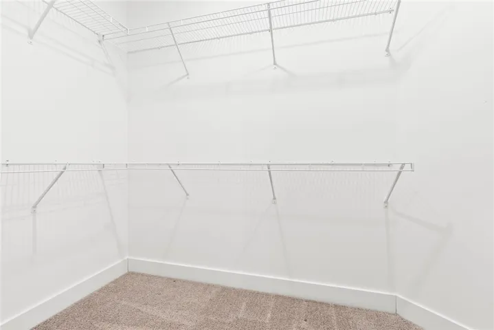 Spacious walk in closet in primary