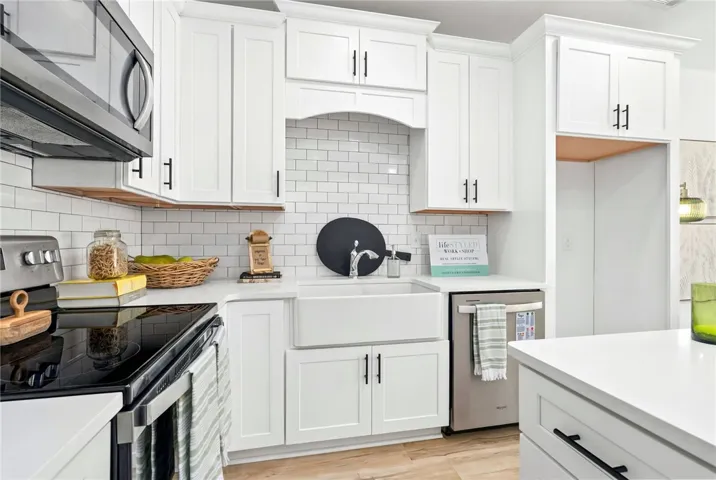 Kitchen has island offering bar seating and a pantry closet for added storage.