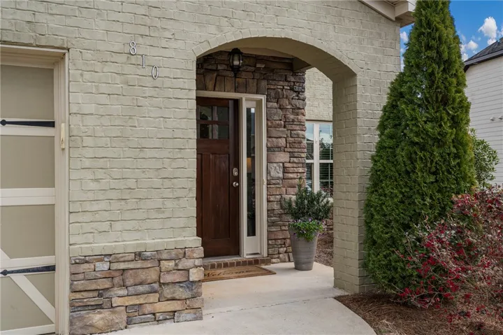 Beautiful bricked front entry combined with stone is a multi dimentional textured appeal