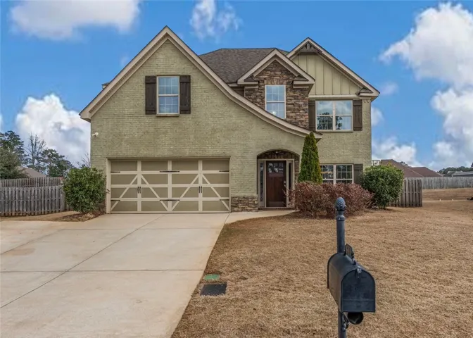 Adorable swooping roofline creates a European cottage appeal