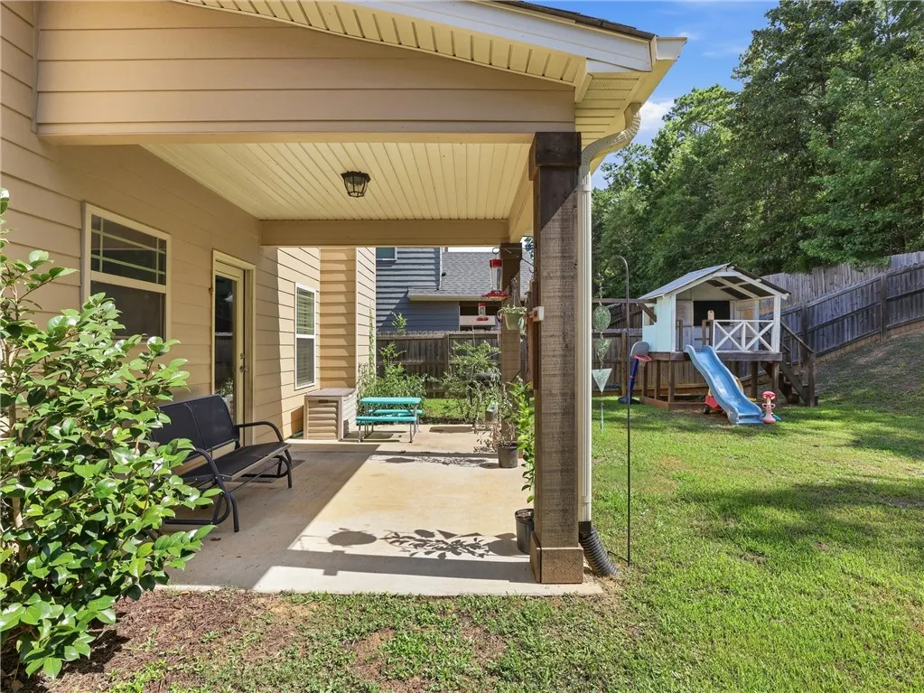 A spacious covered patio provides a delightful outdoor living area overlooking the private backyard.