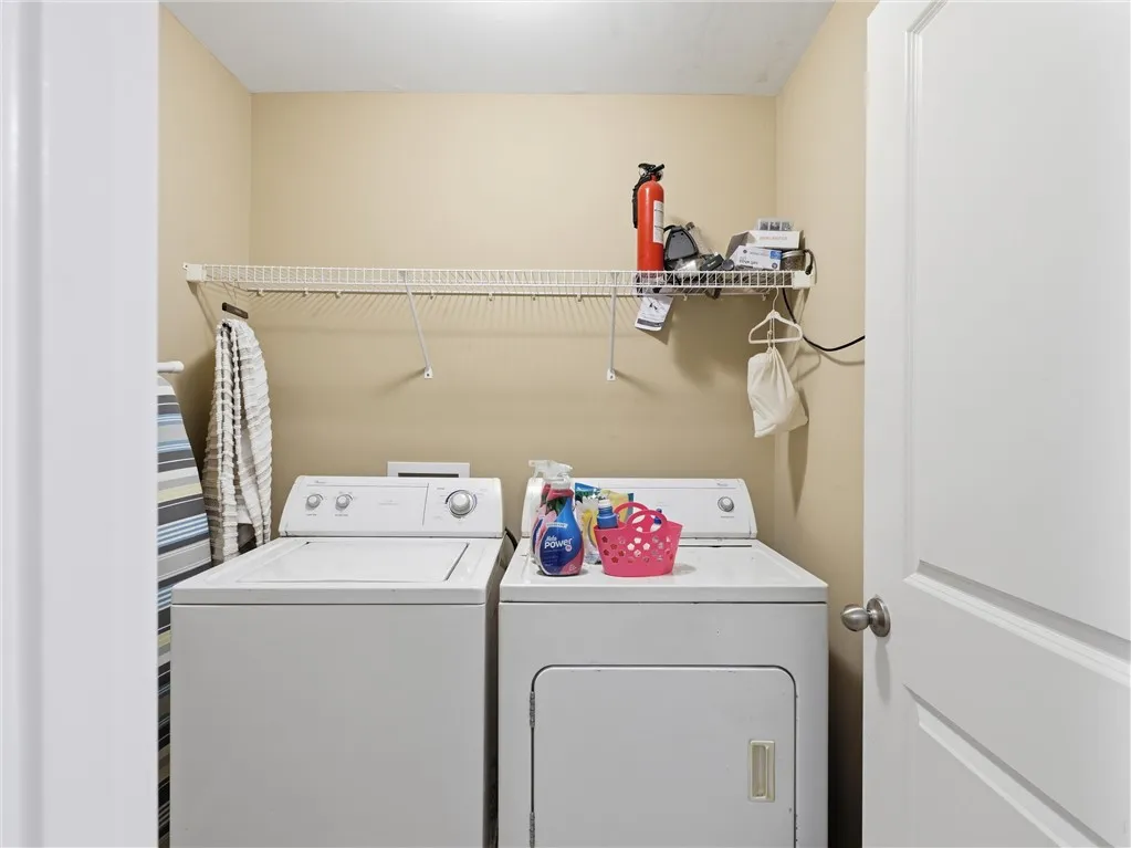 A dedicated laundry room with convenient washer and dryer hookups and overhead storage.