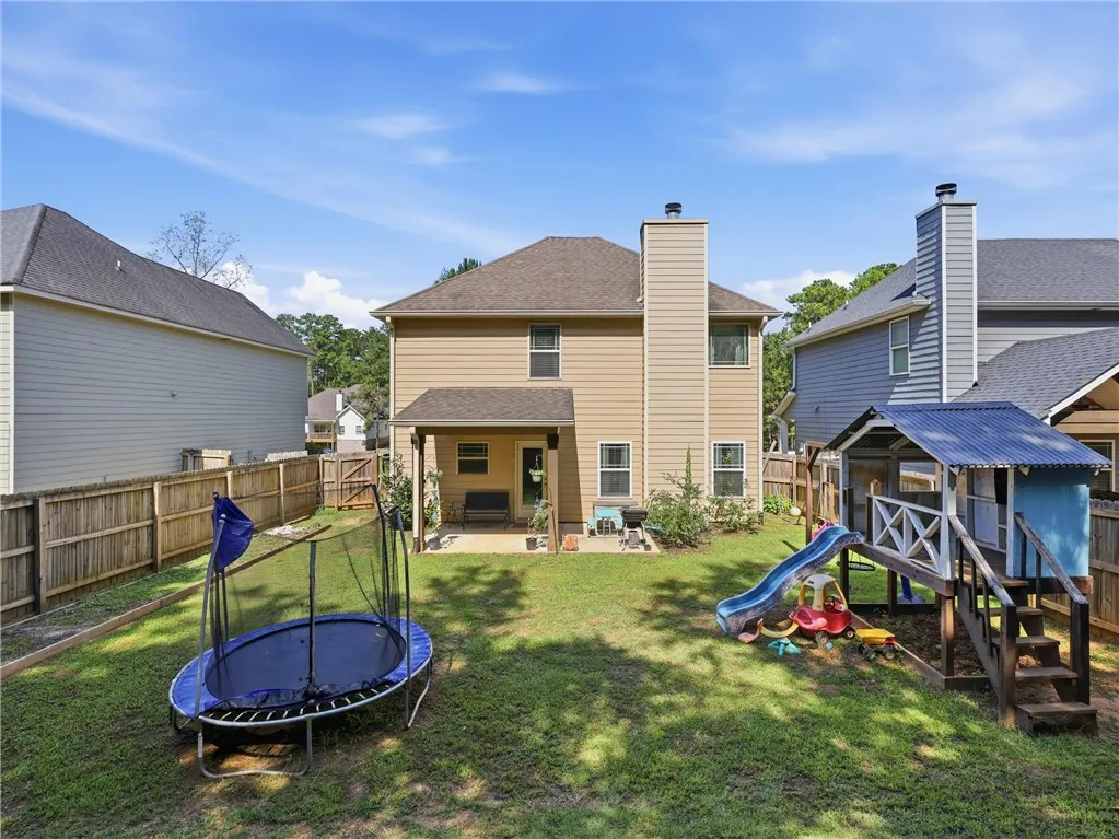 A private, fenced backyard offers ample space for recreation and outdoor enjoyment.