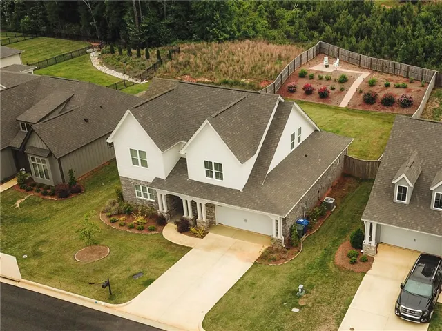 This charming home offers curb appeal with a well-maintained lawn and an inviting front entrance.