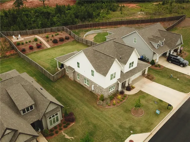 An aerial view captures the charming homes nestled in a vibrant, verdant landscape.