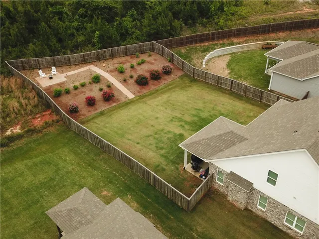 This expansive backyard features a meticulously fenced yard, perfect for outdoor enjoyment and privacy.