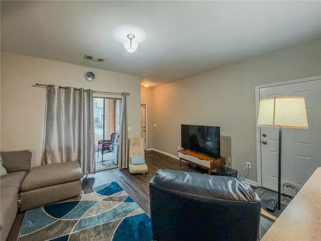 Living room opens up to patio space and garage.
