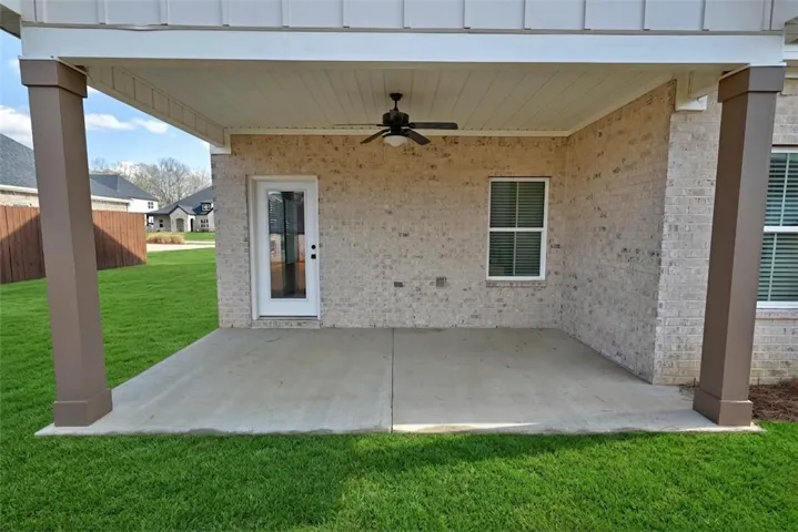 Enjoy outdoor living on this covered back patio, perfect for relaxation and entertaining.