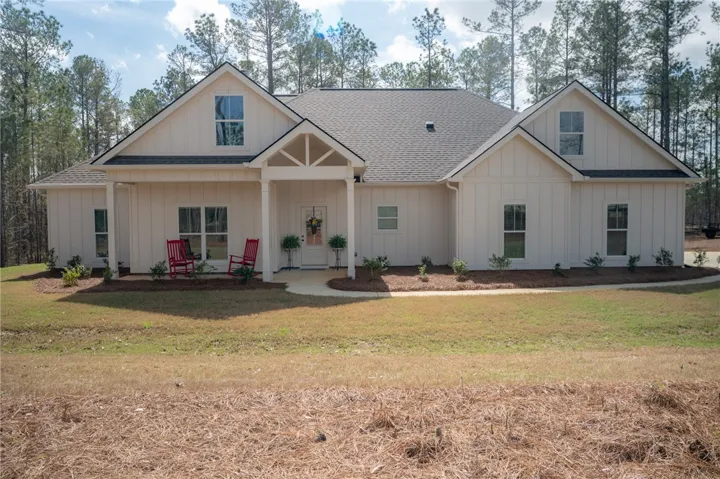 A classic facade with a welcoming porch entry & crisp board & batten siding! Welcome to a southern dream!