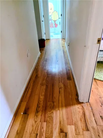 Hall to bedrooms and baths.  Hardwood floors