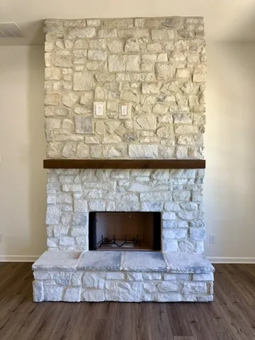 A commanding stone fireplace with a warm wood mantel creates a captivating focal point.