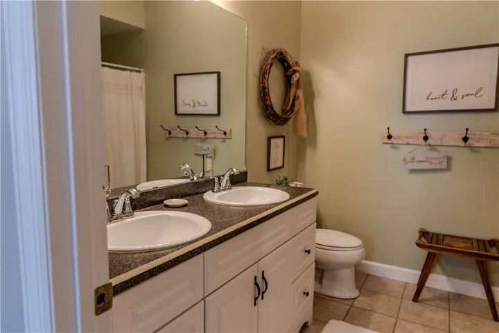 Tiled Master bath with double vanity sinks, walk-in shower & garden tub.