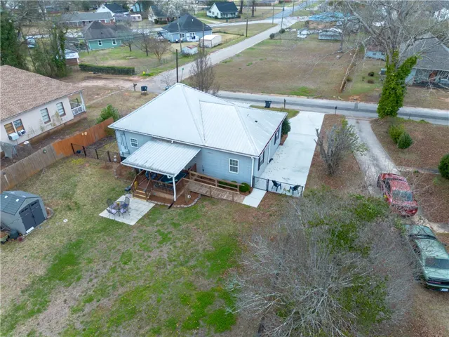 Aerial view of the back yard with back porch & shed. Property is 0.44 acres.