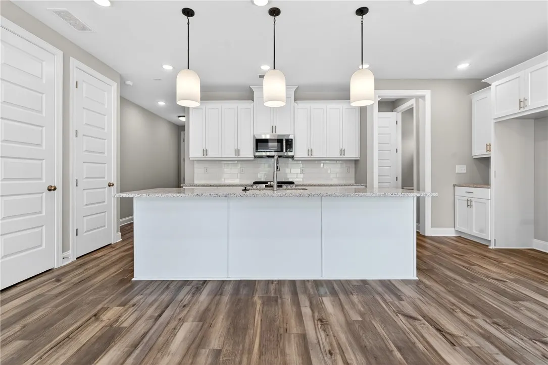 Culinary creations come to life in this kitchen, boasting an island and recessed lighting.