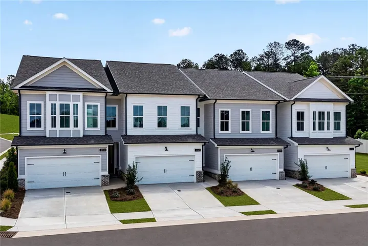 These modern townhomes feature attached garages and tidy landscaping for effortless urban living.